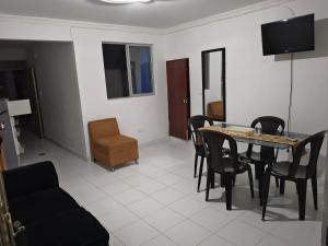 a living room with a dining room table and chairs at Felipe's House in Ibagué +7 photos