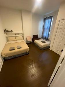 a room with two beds and a door at City Centre Suite, Steps to UofT, TMU, Yonge-Dundas Square in Toronto +14 photos