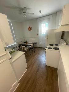 a kitchen with a stove and a table in it at City Centre Suite, Steps to UofT, TMU, Yonge-Dundas Square in Toronto