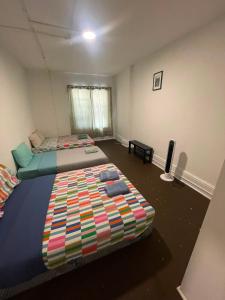 a bedroom with two beds and a television in it at City Centre Suite, Steps to UofT, TMU, Yonge-Dundas Square in Toronto