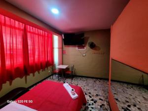 a room with a red room with a basketball hoop at Las Estrellas Hostal in Puente Piedra