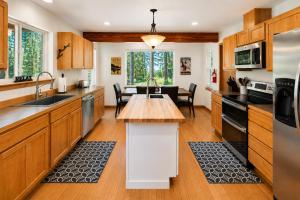 a kitchen with wooden cabinets and a table in it at Just Plain Getaway in Leavenworth
