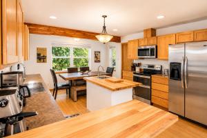 a kitchen with wooden cabinets and a table with a counter top at Just Plain Getaway in Leavenworth