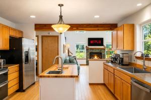 a kitchen with wooden cabinets and a fireplace at Just Plain Getaway in Leavenworth