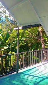 a swimming pool with a fence and trees at Ella Kumi Wood Cabin in Ella