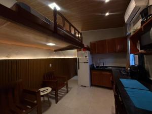 a small kitchen with a table and a refrigerator at Condomínio Feitosa Barros I in Maceió