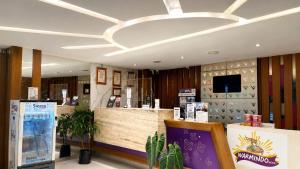 a restaurant with a reception counter and a light at Vio Veteran in Bandung