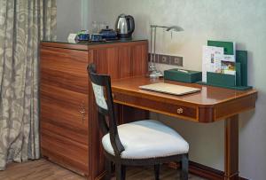 a desk with a laptop on it with a chair at Windsor Plaza Hotel in Ho Chi Minh City