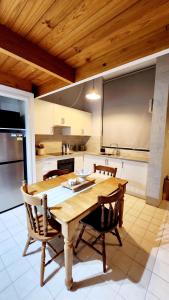 a large kitchen with a wooden table and chairs at Poolside Retreat 250m From Beach Resort Facilities in Mandurah