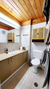 a bathroom with a toilet and a sink at Poolside Retreat 250m From Beach Resort Facilities in Mandurah +9 photos