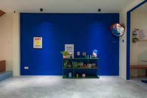 a blue wall with a shelf in a room at Lot 78 in Malacca