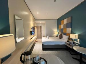 a hotel room with a bed and a mirror at Yes Hotel San Ildefonso Bulacan in Buliran
