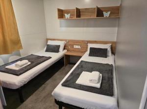 two beds in a small room with towels on them at Holiday Homes Lavanda - Biograd na Moru in Biograd na Moru