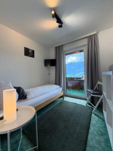 a bedroom with a bed and a large window at Frühstückspension Irschen in Irschen