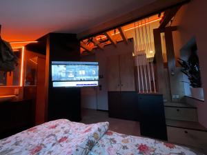 a bedroom with a bed and a television in a room at Gleisbett 12-1 in Meiningen +8 photos