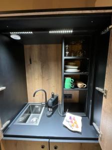 a small kitchen with a sink and a counter top at Gleisbett 12-1 in Meiningen