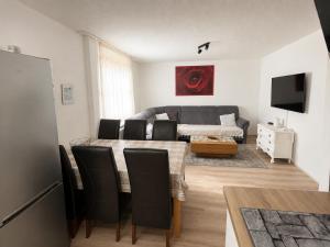 a living room with a table and a couch at FERIENHAUS AyNa, direkt an der Schweizer Grenze in Bad Säckingen