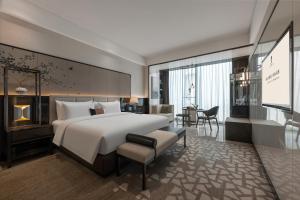 a hotel room with a bed and a desk at Rainbird Hotel in Chengdu +34 photos