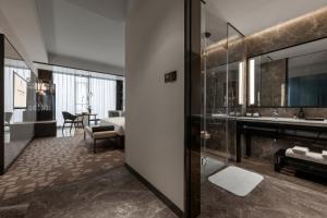 a bathroom with a sink and a mirror at Rainbird Hotel in Chengdu