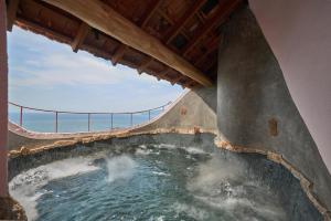 a hot tub with the ocean in the background at Ibala Hotel & Spa in Nha Trang