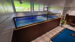 a large swimming pool in a building at Tam Cốc Hà Anh Hotel in Văn Lâm
