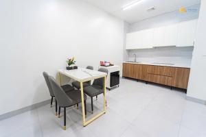 a kitchen with a table and chairs in a room at Phu Hai Apartment in Dong Hoi