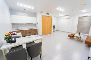 a kitchen with a table and chairs in a room at Phu Hai Apartment in Dong Hoi +16 photos
