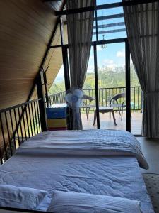 a bedroom with a bed on a balcony at Annfield Cabana in Hatton +15 photos