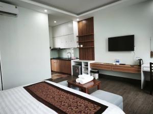 a hotel room with a bed and a kitchen at Kakashi Hotel Phú Quốc in Phú Quốc +81 photos