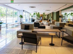 a lobby with couches and tables and windows at Novotel Sao Paulo Morumbi in São Paulo +267 photos
