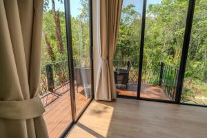 a room with sliding glass doors looking out onto a deck at ArtiZen Hideout near Hin Kong Beach in Hinkong