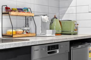 a kitchen counter with a toaster and other appliances at Dulwich Studio in Rose Park