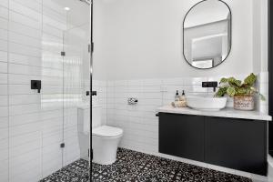 a bathroom with a sink and a toilet and a mirror at Dulwich Studio in Rose Park
