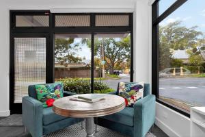 two chairs and a table in front of a window at Dulwich Studio in Rose Park