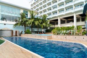 a large swimming pool in front of a building at Palasia Hotel in Koror