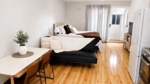 a living room with a couch and a bed at Verandah Suite in Seacliff