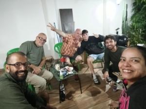 a group of people sitting in a living room at Hostel Chaton in Asunción