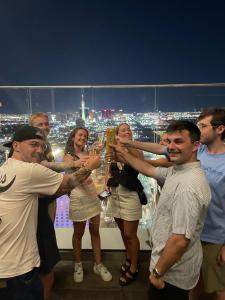 a group of people holding up glasses of champagne at Sin City Hostel in Las Vegas