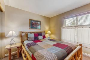 a bedroom with a large bed and a window at On the Rapids - A Unit in Grand Lake