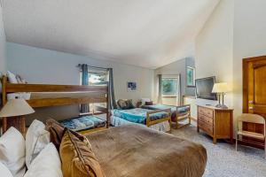 a bedroom with two bunk beds and a tv at Tyra I B3D in Breckenridge +57 photos