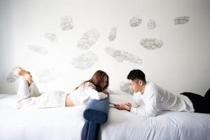 a man and a woman laying on a bed at Aloft by Marriott Osaka Umeda in Osaka