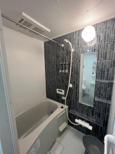 a bathroom with a bath tub and a sink at One Point Five in Tokyo +107 photos