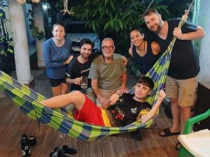 a group of people posing for a picture in a hammock at Hostel Chaton in Asunción