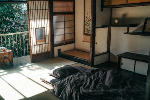 a room with a bed on the floor in front of a window at B&B Hachi in Kyoto