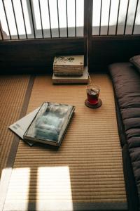 a book and a candle on the floor in a room at B&B Hachi in Kyoto