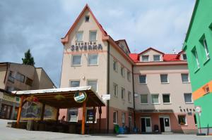 a large building with a sign on the side of it at Penzión Severka in Oravská Lesná