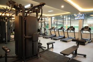 a gym with rows of treadmills and ellipticals at Juwel Villa Ubud in Ubud