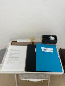 a table with a book and other items on it at One Point Five in Tokyo