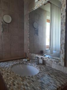 a bathroom with a sink and a large mirror at Adriatic Lifestyle Apartment in Stari Grad +37 photos