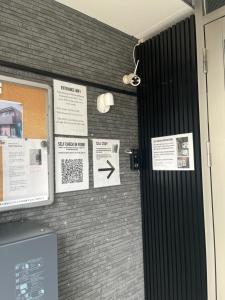 a brick wall with signs on it at One Point Five in Tokyo